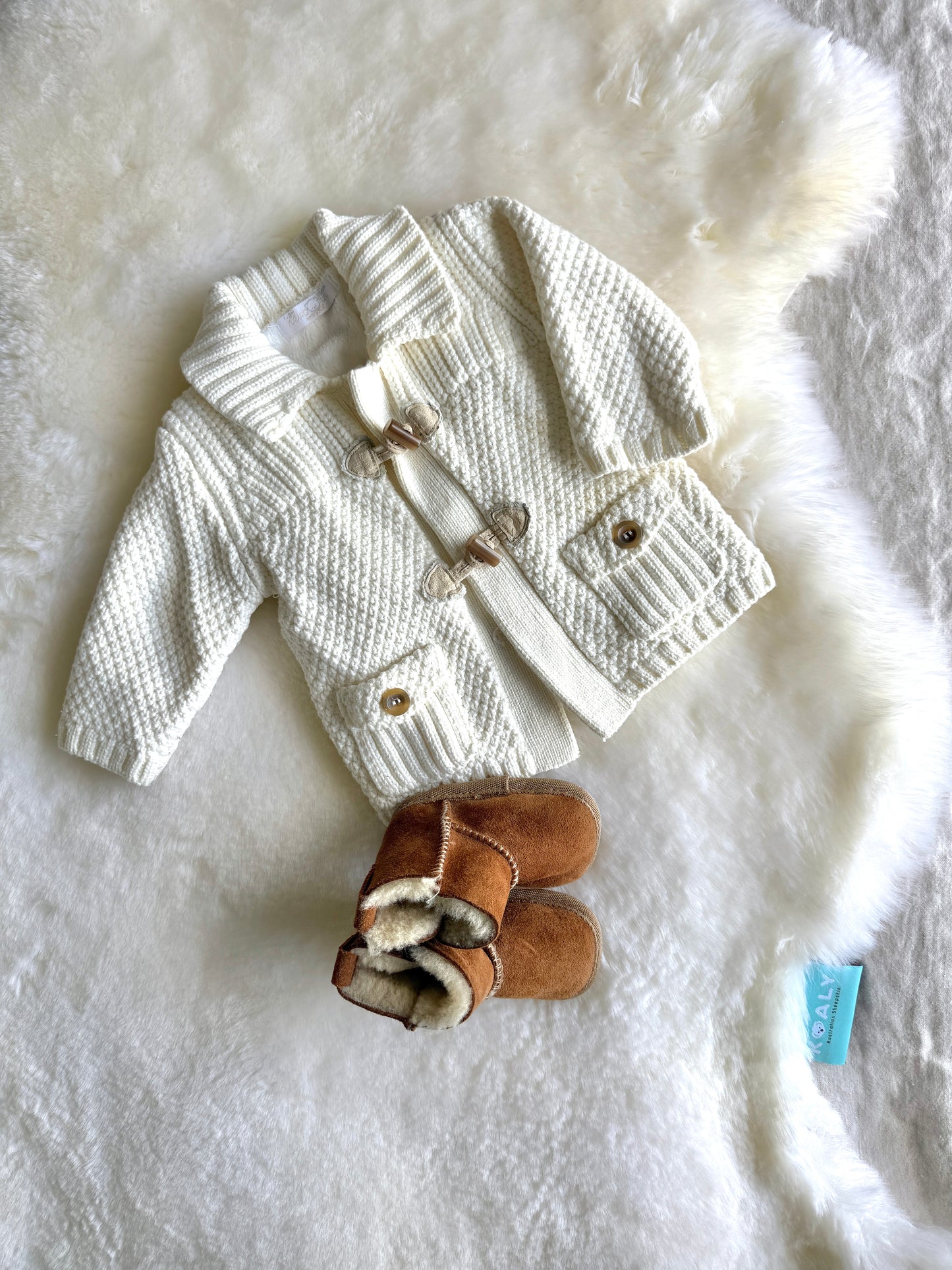 White Australian Sheepskin with baby clothes