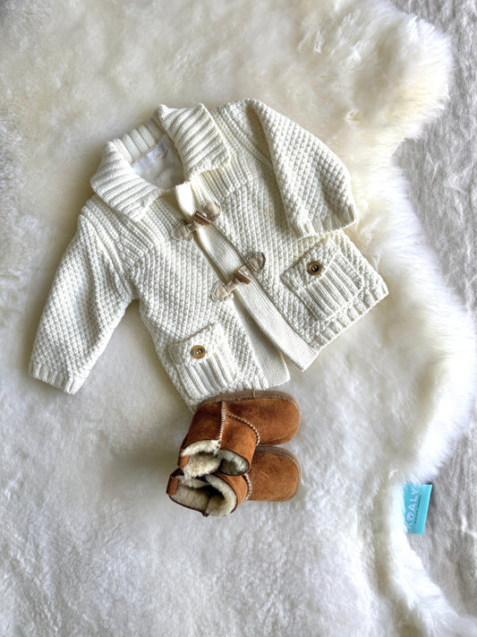White Australian Sheepskin with baby clothes